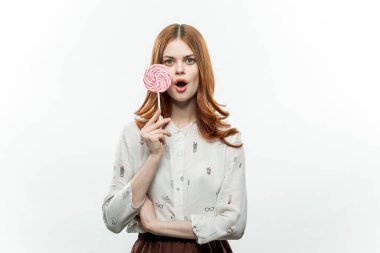 Yuvarlak yüzlü, ağzı açık, neşeli, güzel bir kadın.