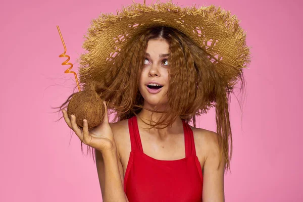 Mulher em chapéu de praia coquetel de coco e diversão férias fundo rosa — Fotografia de Stock