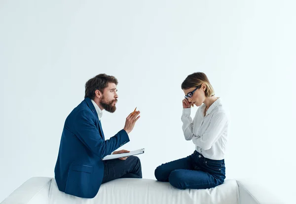 Business men and women sit on the couch communicating employees psychology work