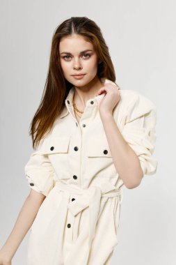 Yakın plan, açık arkaplanda siyah tulumlu kadının görüntüsü.