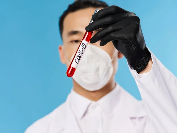Asian male male protective suit black gloves covid-19 blood test — стокове фото