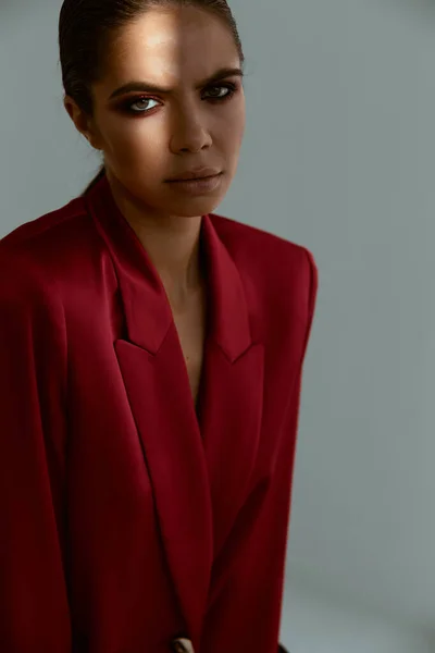 Mulher com maquiagem em seu rosto casaco vermelho modelo de decoração de luxo — Fotografia de Stock