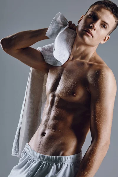 Athletic guy with pumped up abs white towels posing close-up — 스톡 사진