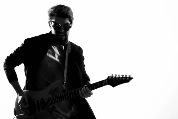 Cheerful male musician in leather jacket with sunglasses guitar performing — Stock Photo, Image