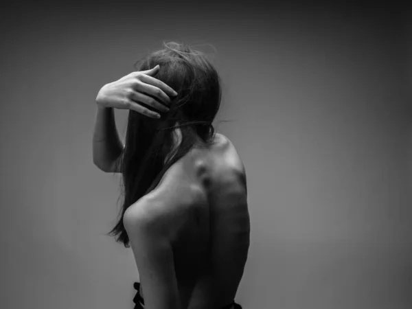 Black and white photo of a long hair model touching herself with hands — Stock Photo, Image