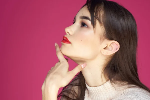Vrouw met rode lippen heldere make-up witte blouse lang haar roze achtergrond — Stockfoto