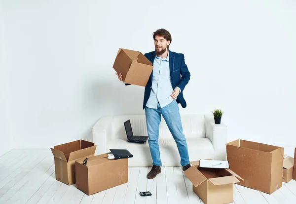 Man in a suit unpacks things emotions office technology lifestyle work in a new place