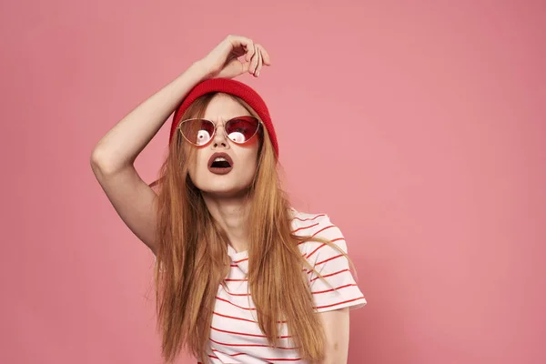 Lunettes de soleil femme à la mode et chapeau rouge studio rose fond mode — Photo