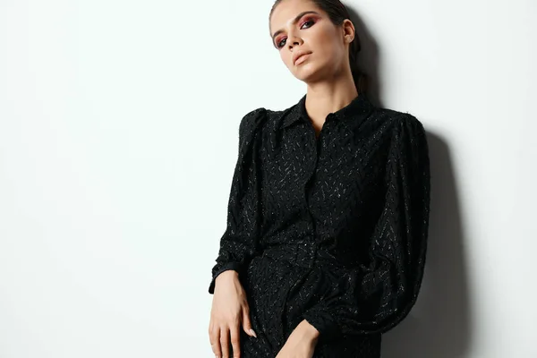 Attractive brunette in black dress modern style glamor studio — Foto de Stock