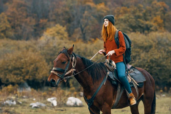 Woman riding a horse on nature mountains travel adventure — Stock Photo, Image