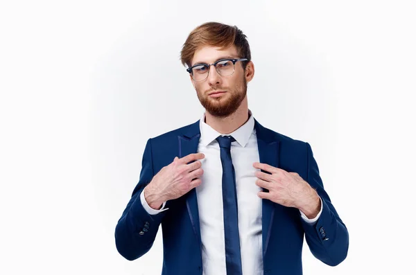 Un hombre rubio en gafas y en un traje clásico endereza su corbata alrededor de su cuello y chaqueta — Foto de Stock