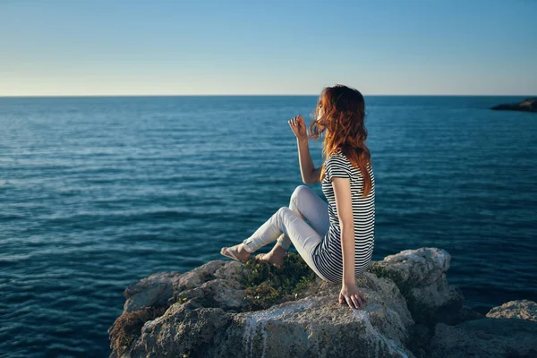 Beautiful woman on vacation in the mountains near the sea gesturing with her hands and sunset — Stock Photo, Image