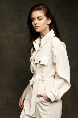 Siyah arka planda beyaz tulumlu kadın makyaj modeli.