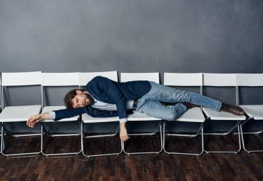 Beyaz sandalyeye uzanmış bir adam duyguları kovma konusunda uzmandır.