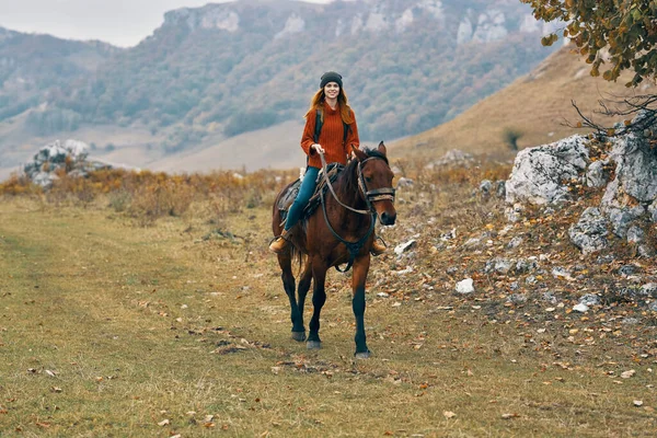 Woman hiker riding horse mountains landscape travel adventure — Stock Photo, Image