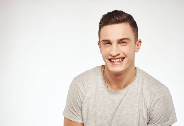 Neşeli, yakışıklı adam gri tişörtlü, kırpık manzaralı.