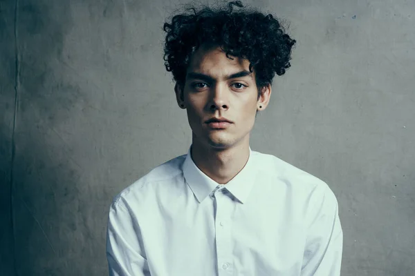 Chico con pelo rizado en una camisa blanca pelo rizado emociones oficial —  Fotos de Stock