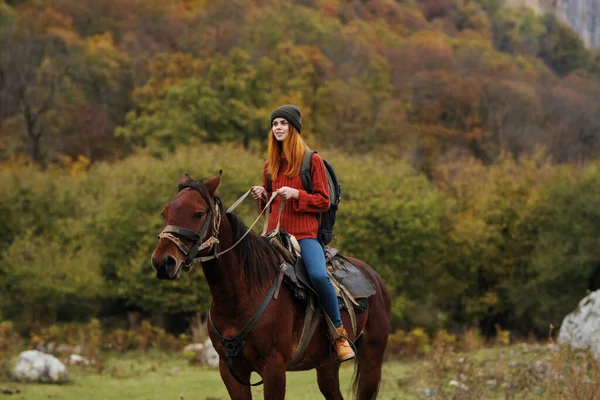 Woman riding a horse on nature mountains travel adventure — Stock Photo, Image