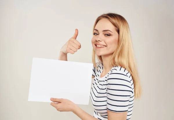 Woman gestures with her hands on a beige background of emotions and a white sheet of paper — Stock Photo, Image