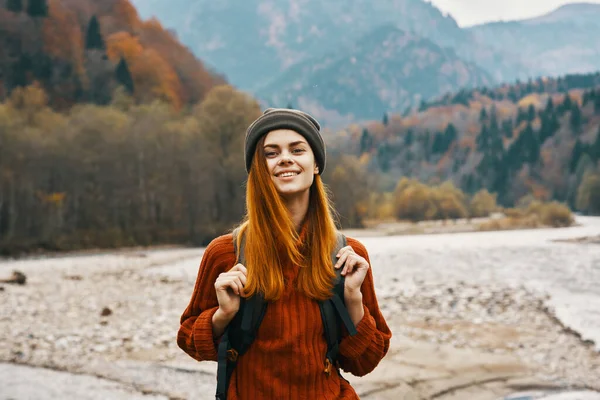 Mujer feliz en el bosque de otoño en las montañas al aire libre con una mochila en su turismo de viaje de vuelta —  Fotos de Stock