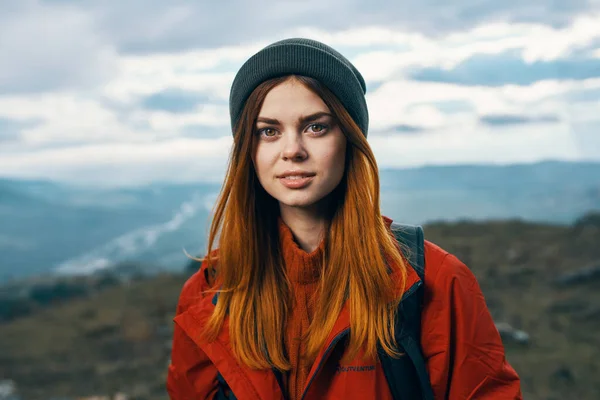 portrait of a woman in warm clothes in the mountains in autumn