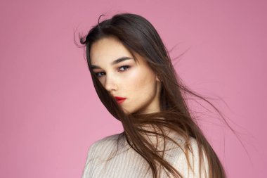 Güzel, esmer, kırmızı dudaklı, beyaz bluz. Yakın plan, çekici, pembe arka plan.