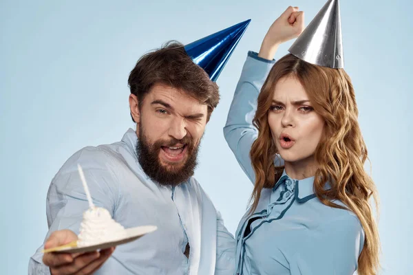 Birthday corporate young man and woman with cake on isolated background disco party