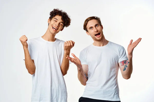 Two men in white t-shirts are standing next to friendship emotions — Stock Photo, Image