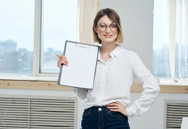 Business woman but we are with a white sheet of paper near the window