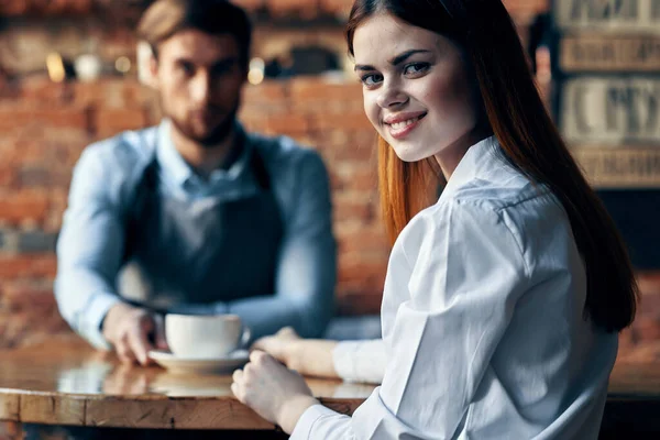 앞치마를 입은 행복 한 여자와 커피를 마시는 남자 바텐더 — 스톡 사진