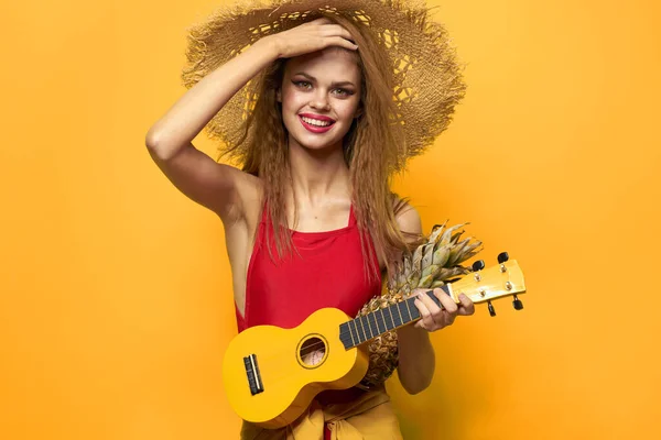 Woman holding Ukulele straw hat lifestyle Exotic yellow background — Stock Photo, Image