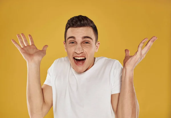 Happy guy on a yellow background gestures with his hands portrait model cropped view — Stock Photo, Image
