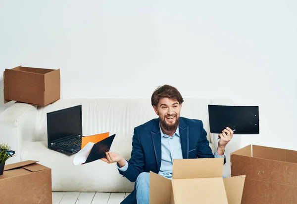 man unpacking boxes stuff office professional job official