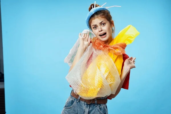 Женщина держит мешок с мусором на синем фоне загрязнения промышленности очистки — стоковое фото