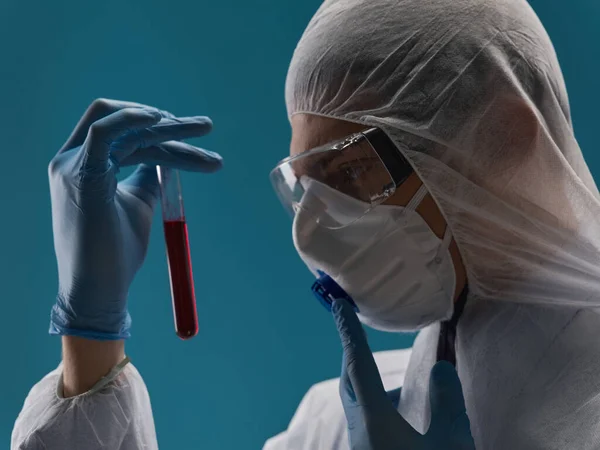 Médico con líquido en frasco laboratorio coronavirus infección guantes azules gafas —  Fotos de Stock