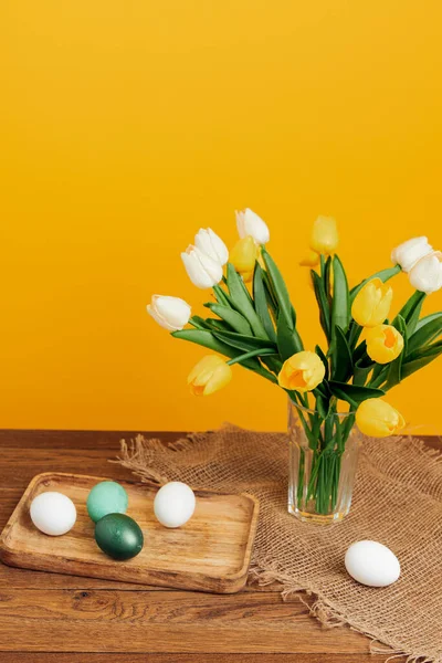 bunch of flowers easter eggs holiday decoration yellow background