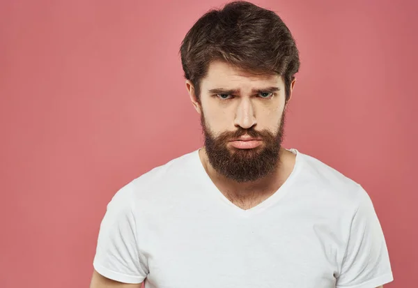 Man with sad face on pink background