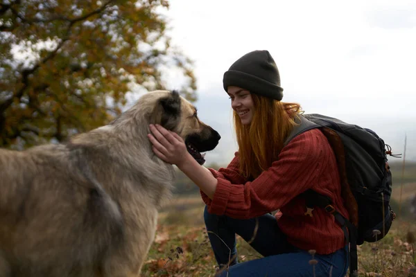 Женщины-туристы играют с собакой на открытом воздухе путешествия радость дружбы — стоковое фото