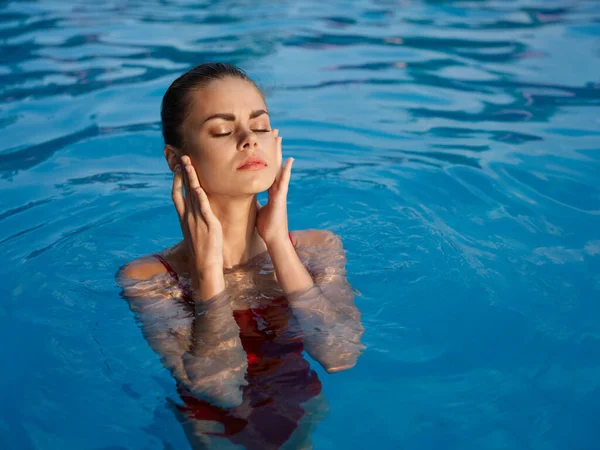 Женщина в купальнике в бассейне на открытом воздухе закрытые глаза роскошный досуг — стоковое фото