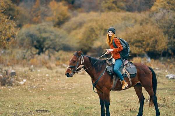 Woman hiker in the mountains riding a horse travel lifestyle — Stock Photo, Image