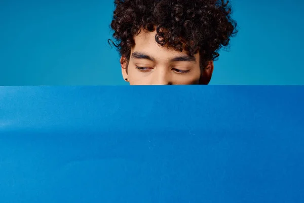 guy with curly hair blue poppy poster advertising