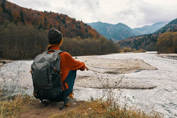 Femme en automne dans les montagnes avec un sac à dos sur ses épaules Voyage tourisme rivière modèle — Photo