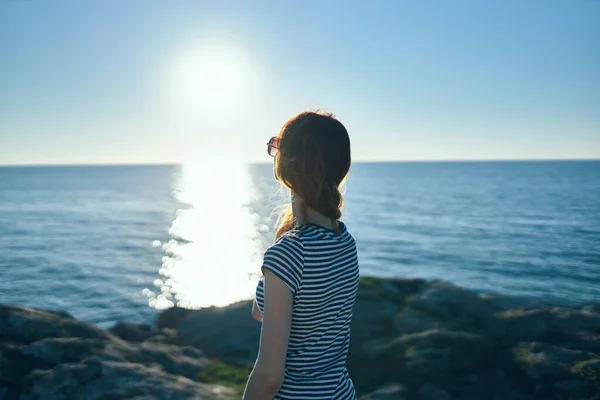 Woman in the mountains look at the sunset summer travel vacation back view — Stock Photo, Image