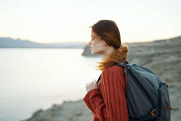 Donna viaggia in montagna nella natura vicino al mare vista laterale — Foto Stock