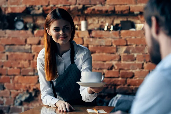 Bella donna cameriere porta caffè servizio muro di mattoni — Foto Stock