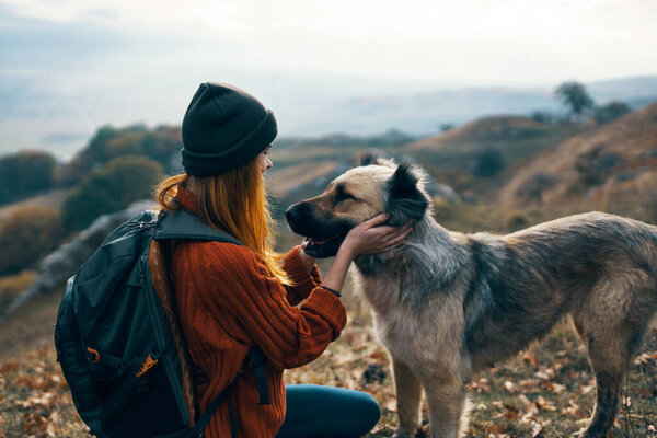 woman next to a dog outdoors vacation friendship