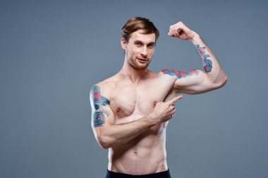 Gövdesi şişmiş sporcu vücut geliştirici Fitness mezurası ve kol kasları güçlü.