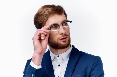 Gözlüklü yakışıklı bir adamın portresi ve hafif arka planda klasik bir takım elbise.