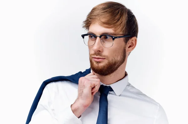 Blonďatý muž v brýlích s bundou na rameni a kravatu košili světlo na pozadí — Stock fotografie