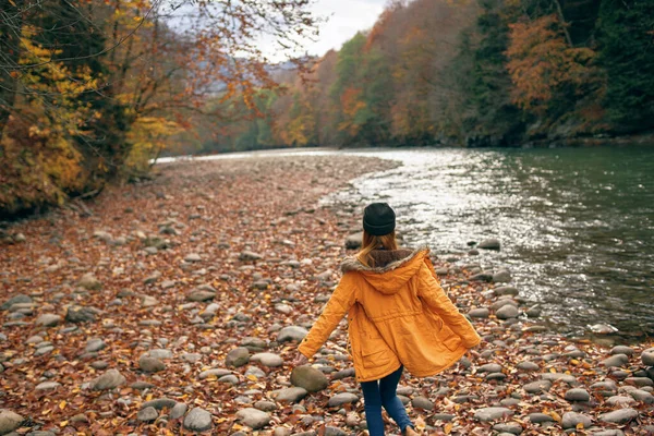 Vrouw wandelen in het bos langs de rivier herfst reizen — Stockfoto